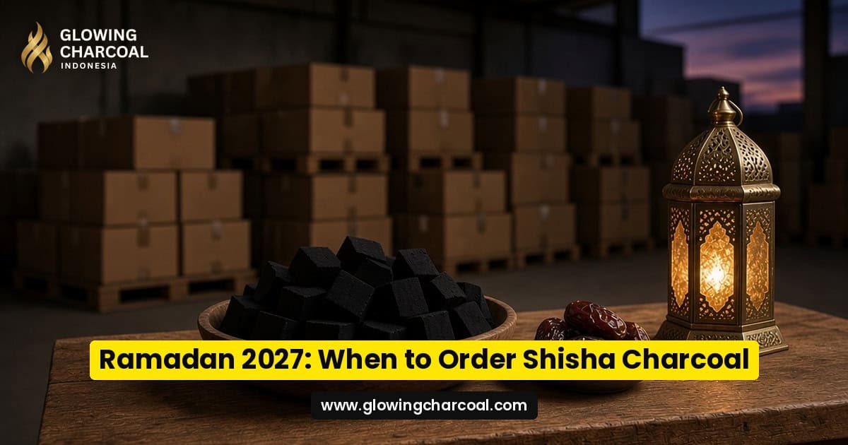 Uniform deep-black coconut shell shisha charcoal cubes in a wooden bowl beside a brass Ramadan lantern and dates, with stacked export cartons in a warehouse behind